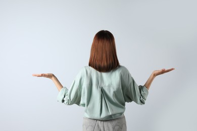 Girl wearing blouse on white background, back view