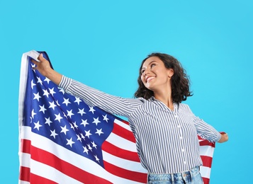 happy young woman with USA flag on blue background
