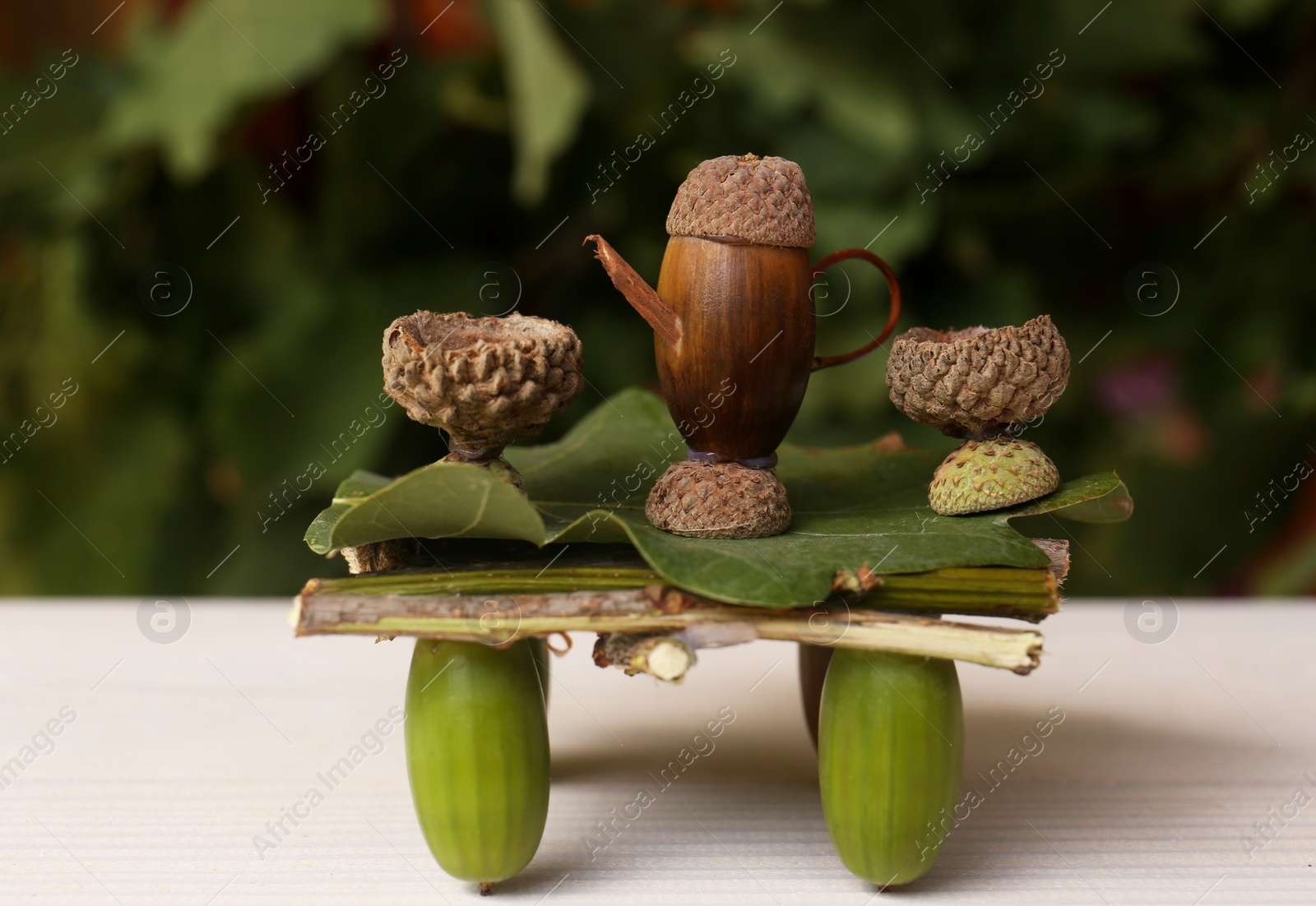 Photo of Tea set composition made of natural materials on white wooden table