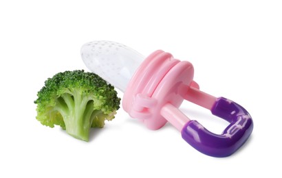 Photo of Empty nibbler and boiled broccoli on white background. Baby feeder
