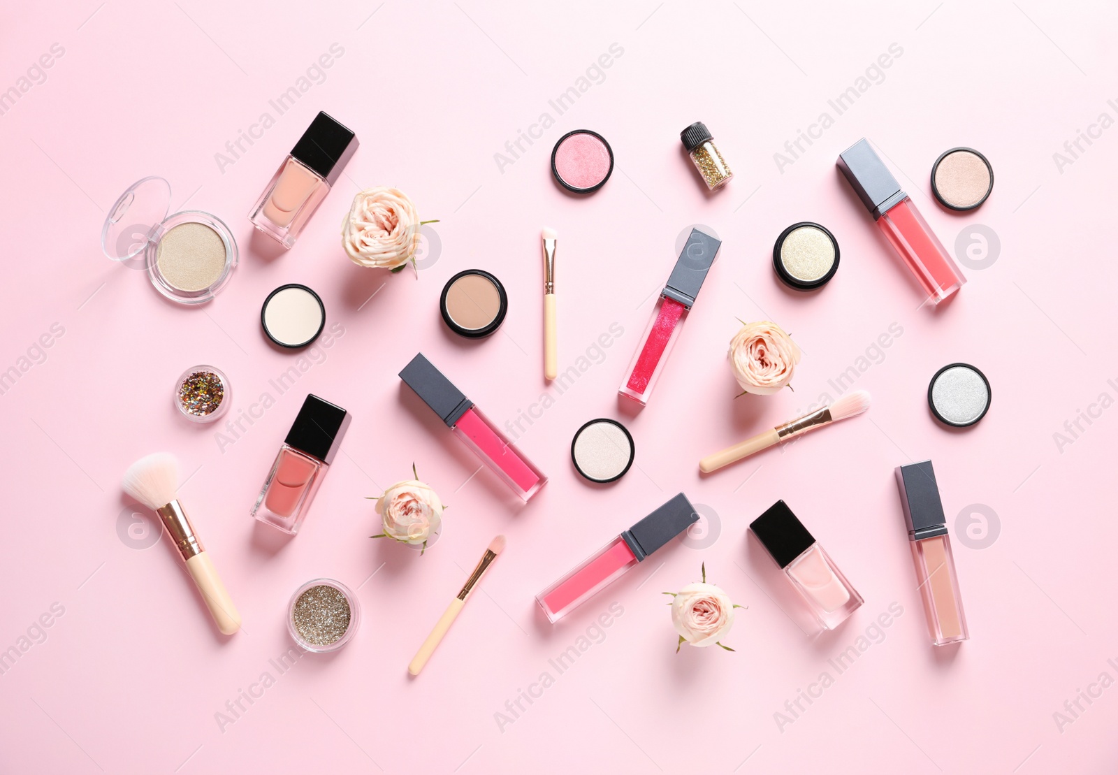 Photo of Beautiful composition with lipsticks and flowers on color background, flat lay