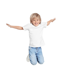 Photo of Happy little boy jumping on light grey background