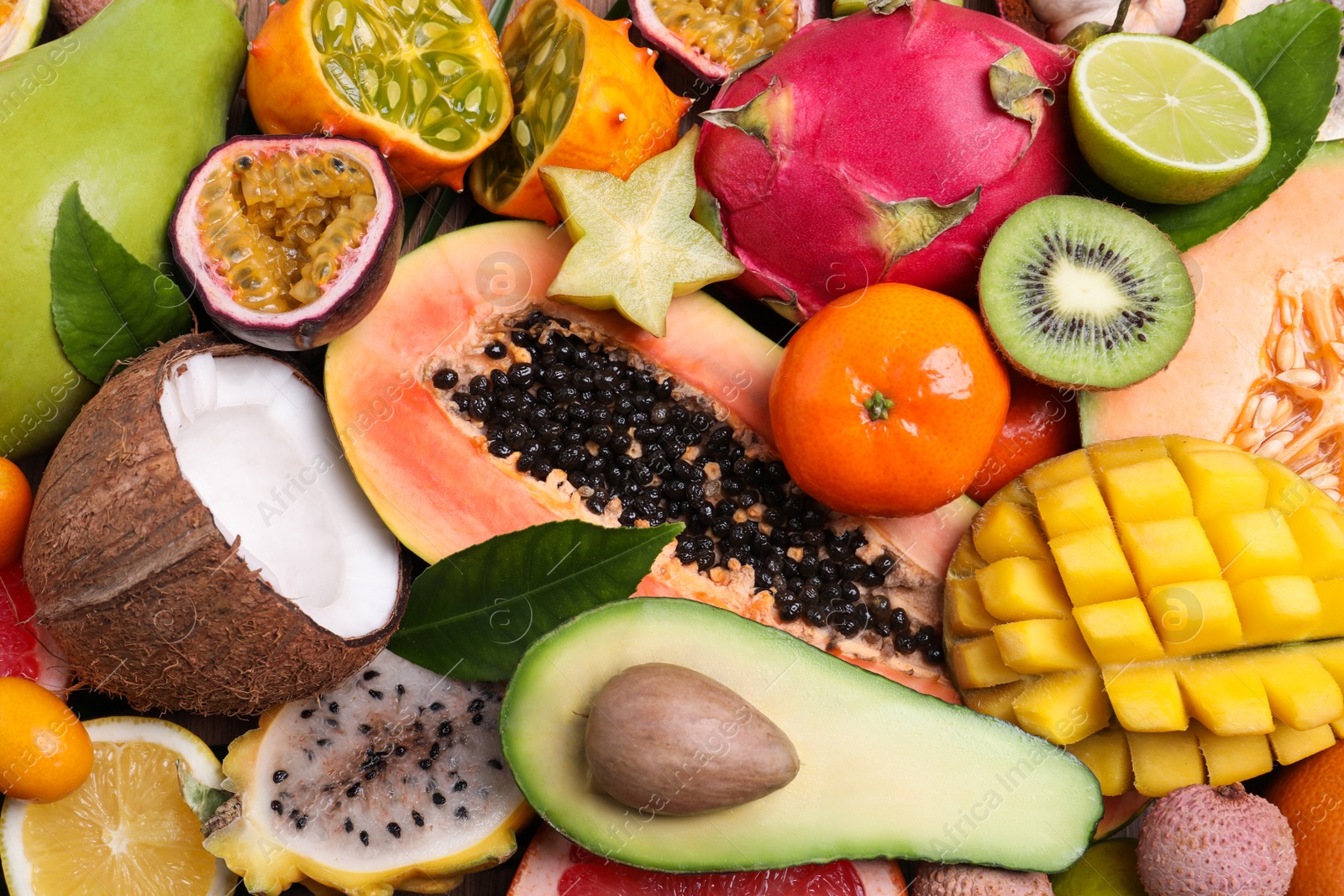 Photo of Different exotic fruits as background, top view