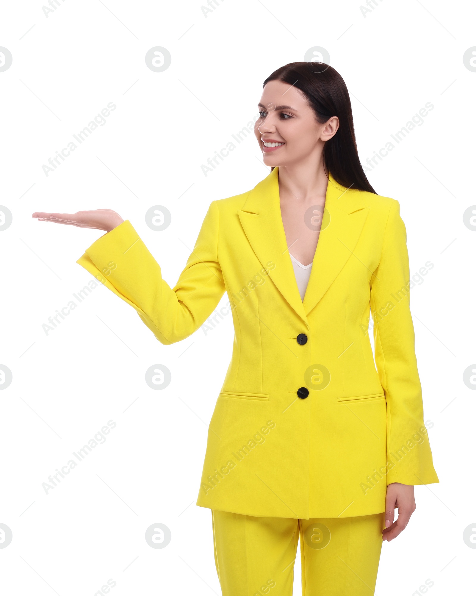 Photo of Beautiful businesswoman in yellow suit pointing at something on white background