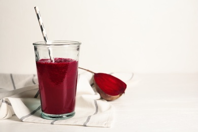 Photo of Glass of tasty beet smoothie on table. Space for text