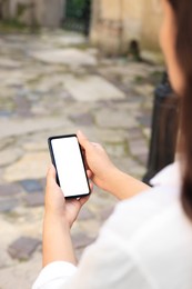Photo of Closeup view of woman using smartphone outdoors