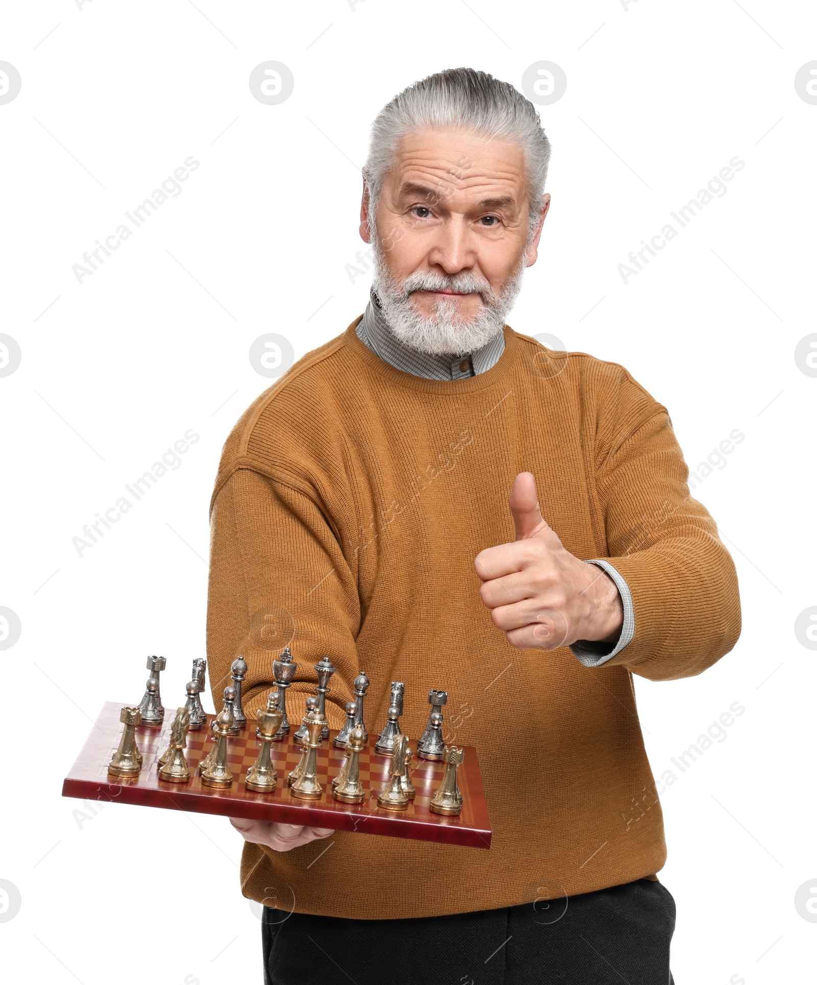 Photo of Man with chessboard and game pieces showing thumbs up on white background