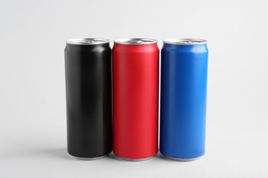 Energy drinks in colorful cans on white background