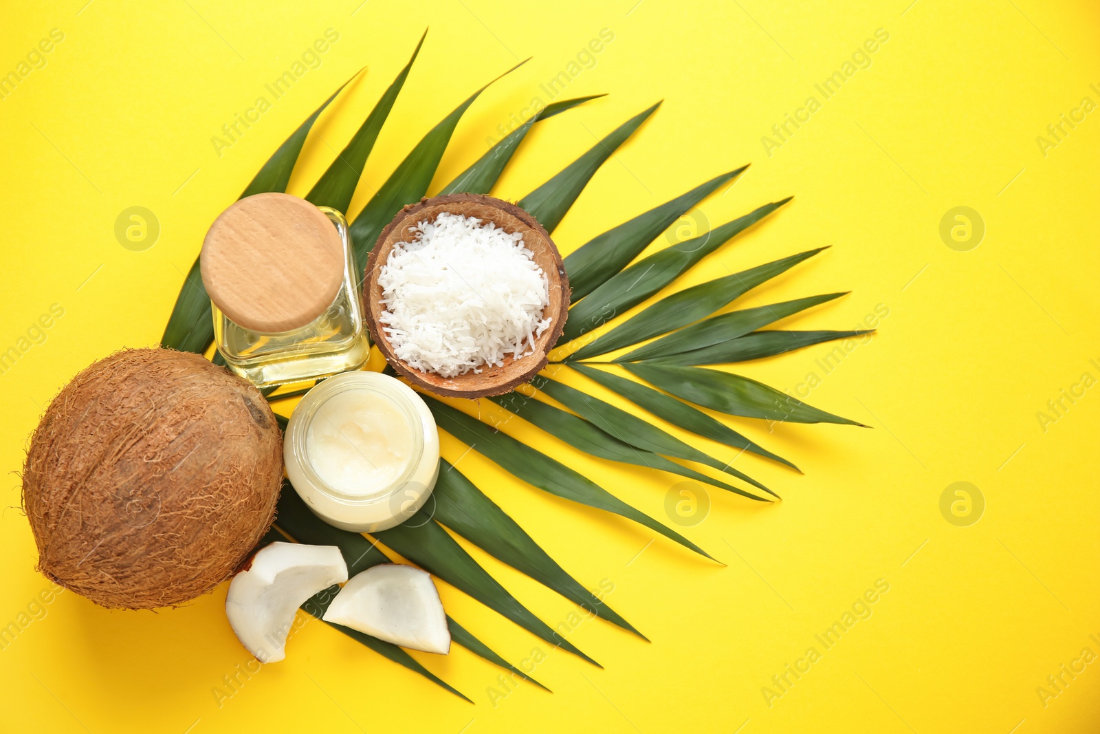 Photo of Beautiful composition with coconut oil and nuts on color background