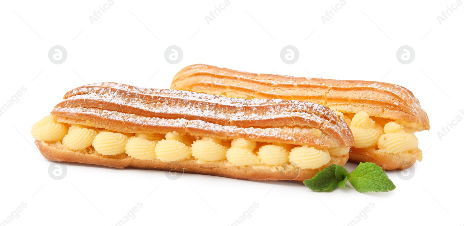 Photo of Delicious eclairs filled with cream and mint isolated on white