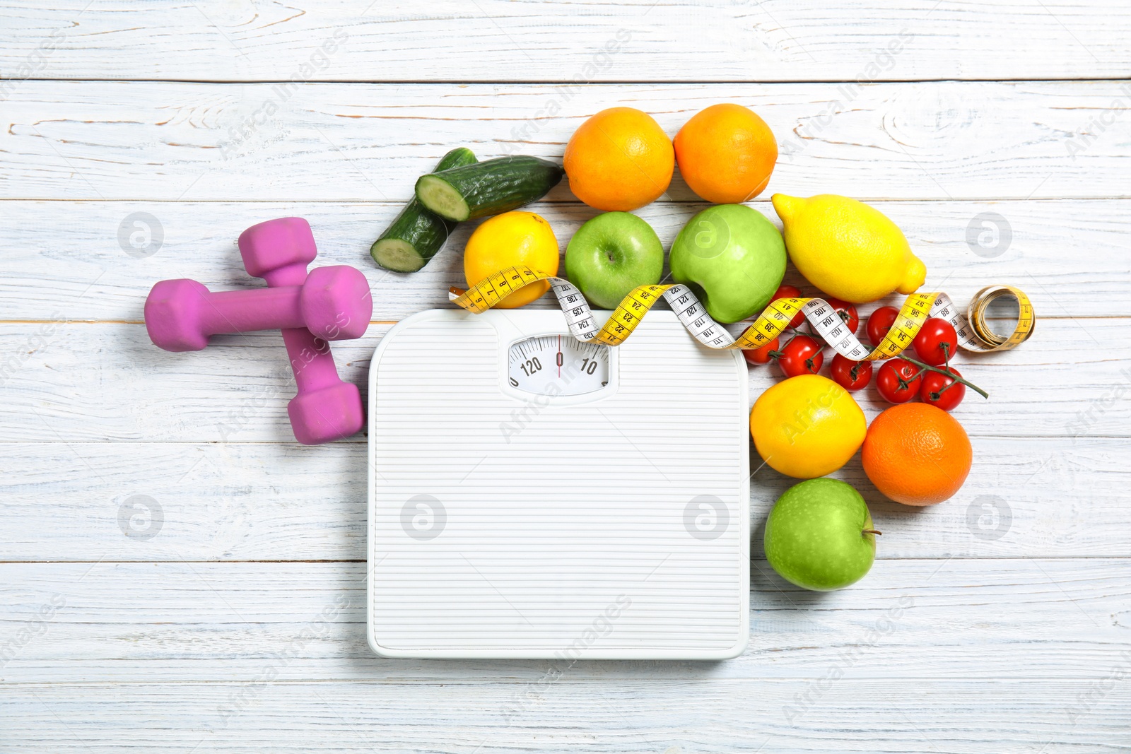 Photo of Flat lay composition with scales, healthy food, measuring tape and dumbbells on wooden background. Weight loss