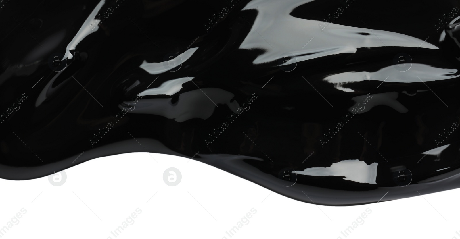 Photo of Blot of black glossy paint on white background, top view