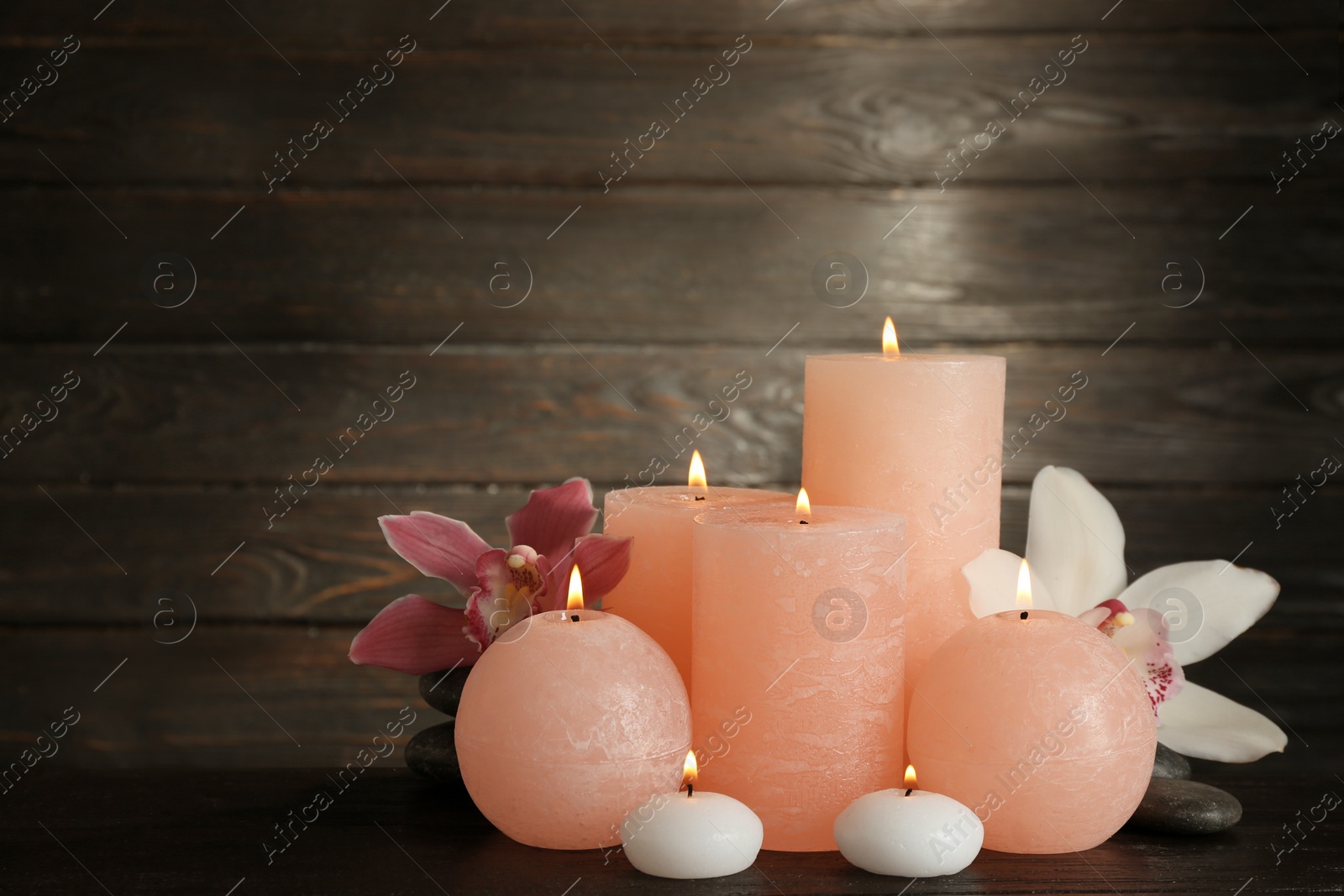 Photo of Beautiful composition with lit candles and flowers on table