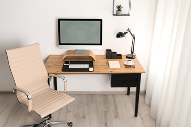 Photo of Stylish workplace interior with modern computer on table. Mockup for design