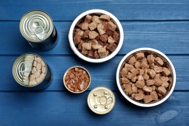 Photo of Wet pet food on blue wooden table, flat lay