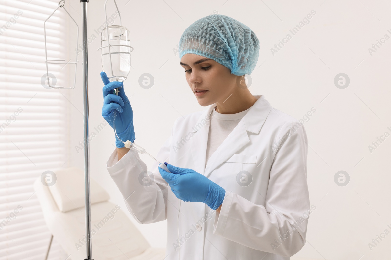 Photo of Nurse setting up IV drip in hospital