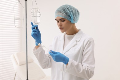 Nurse setting up IV drip in hospital