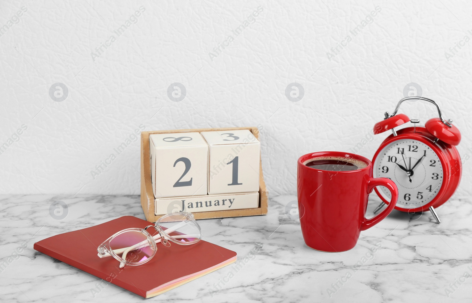Photo of Composition with wooden block calendar and cup of coffee on white marble table