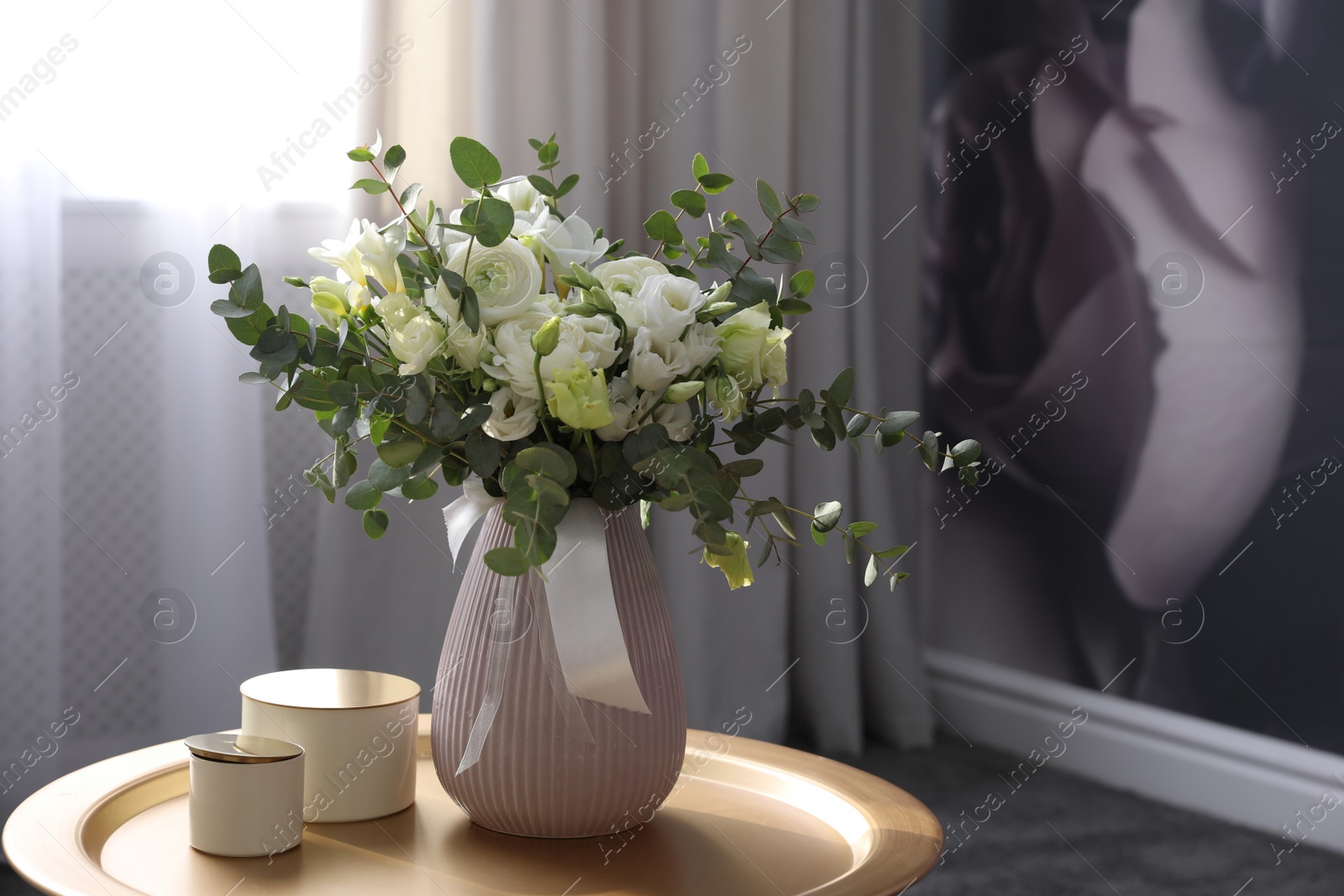 Photo of Beautiful bouquet of flowers on table in room. Stylish interior design