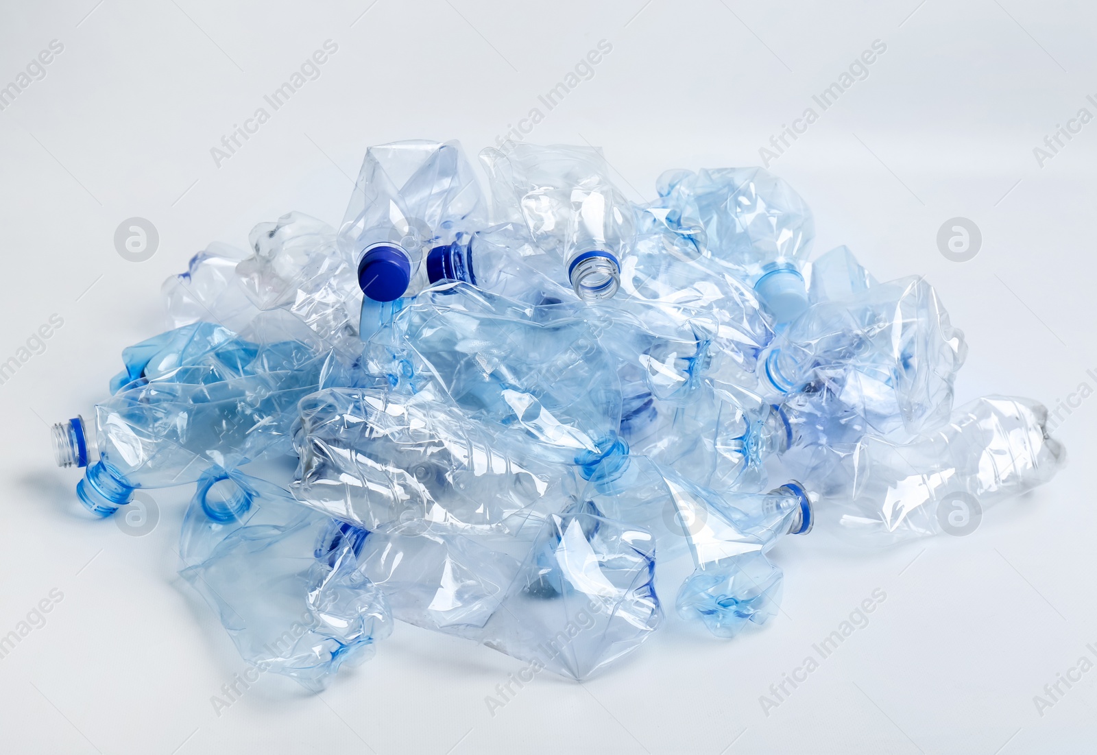 Photo of Heap of used plastic bottles on white background. Recycling problem