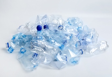 Photo of Heap of used plastic bottles on white background. Recycling problem