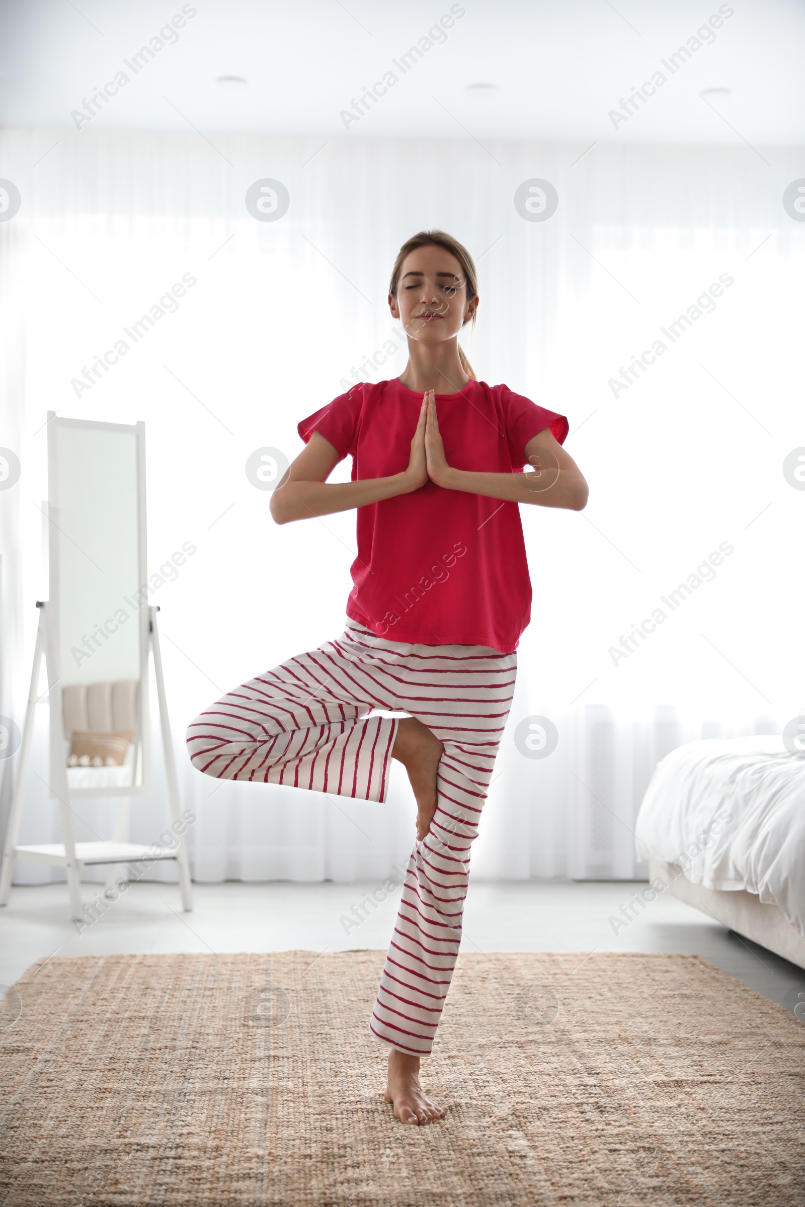 Photo of Young woman doing exercises at home. Morning fitness