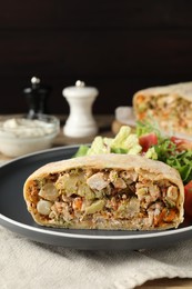 Tasty strudel with chicken and vegetables on table, closeup