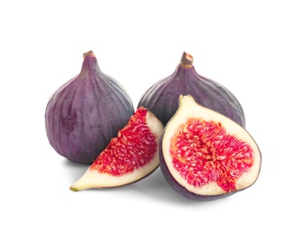 Whole and cut purple figs on white background