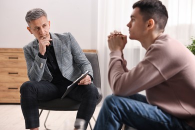 Photo of Professional psychotherapist working with patient in office