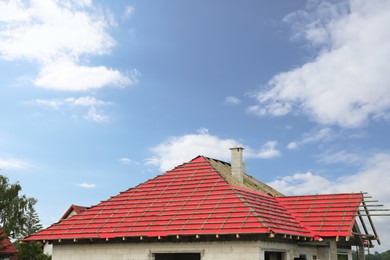 Photo of Roof of house under construction against blue sky