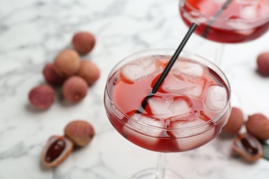 Photo of Delicious lychee cocktail in glass on table, closeup