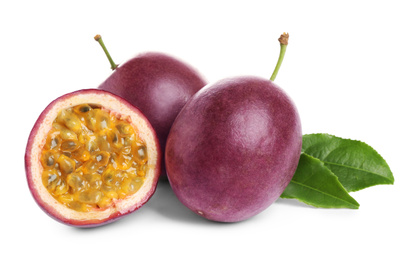 Photo of Fresh ripe passion fruits (maracuyas) with green leaves isolated on white