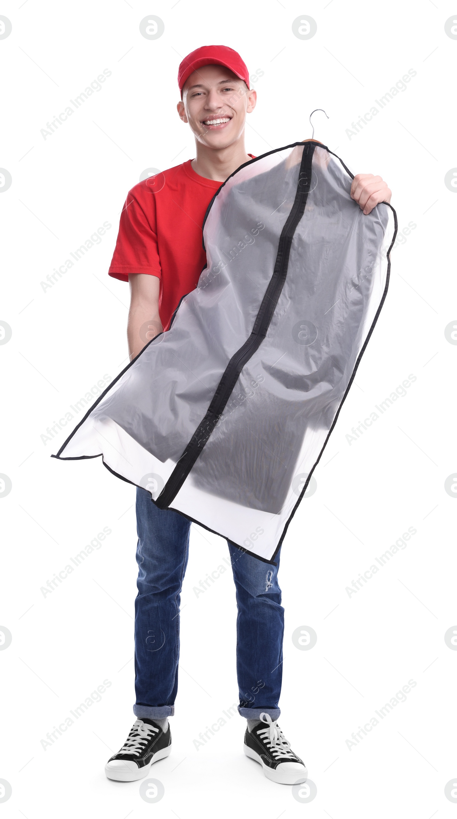 Photo of Dry-cleaning delivery. Happy courier holding garment cover with clothes on white background