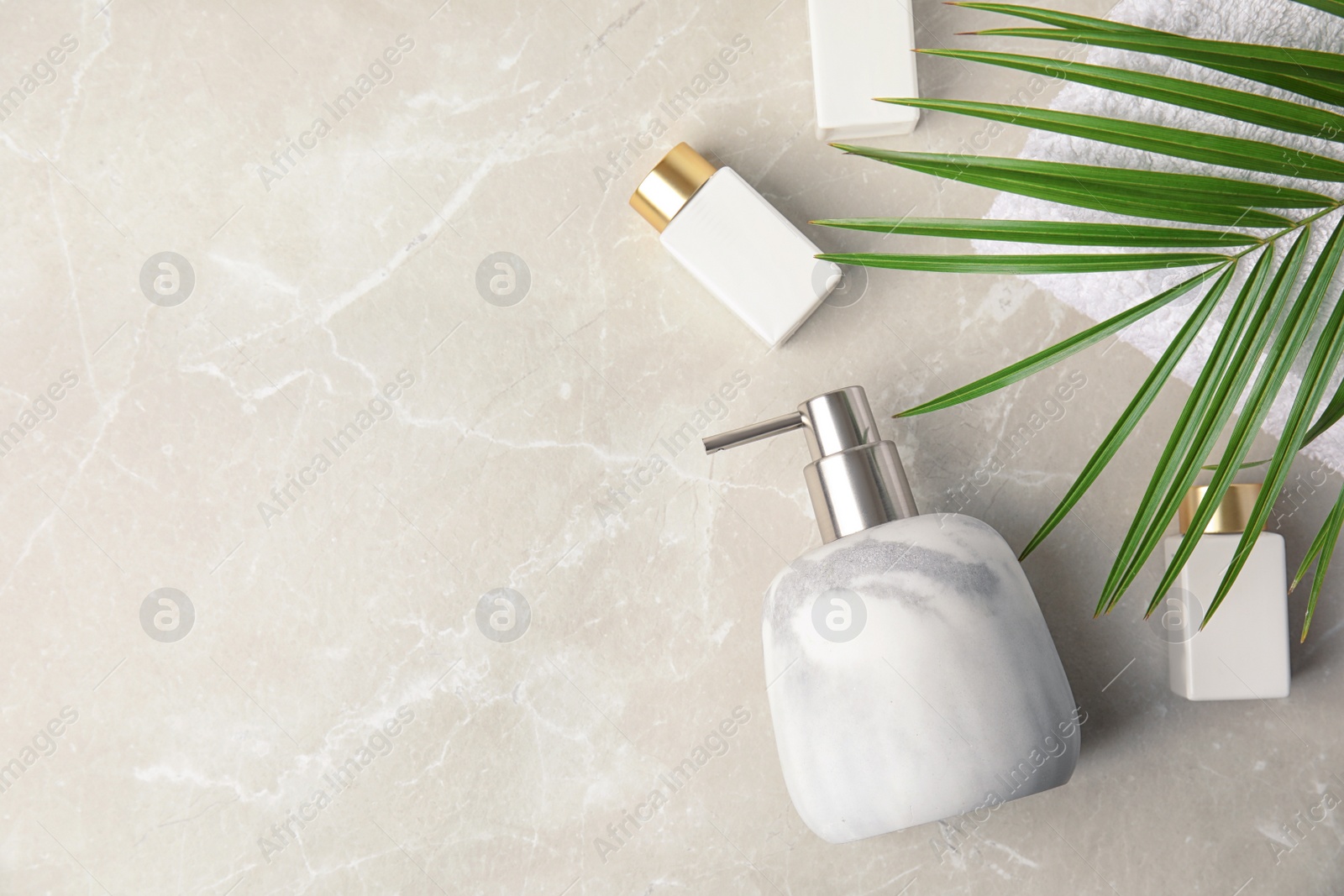 Photo of Flat lay composition with soap dispenser on marble background. Space for text