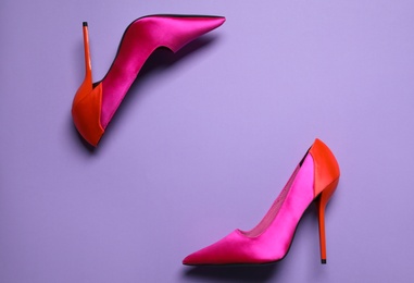 Photo of Pair of beautiful shoes on lilac background, top view. Space for text