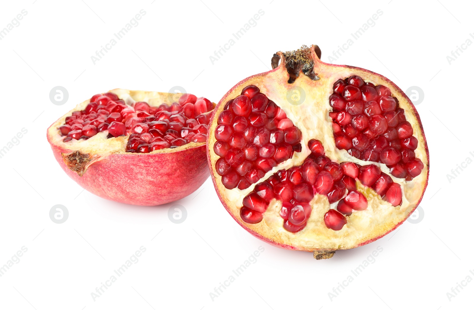 Photo of Halves of fresh pomegranate isolated on white