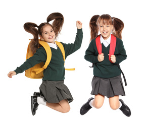 Children in school uniform jumping on white background