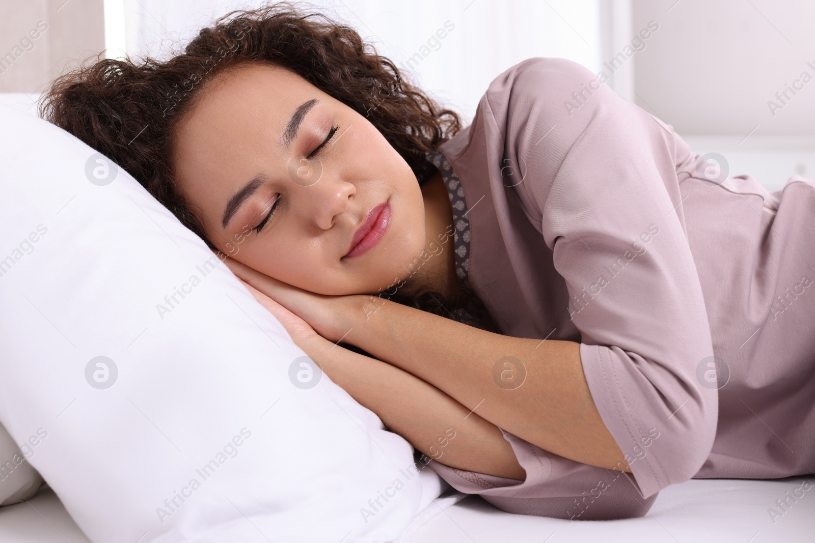 Photo of Beautiful African American woman sleeping in bed at home