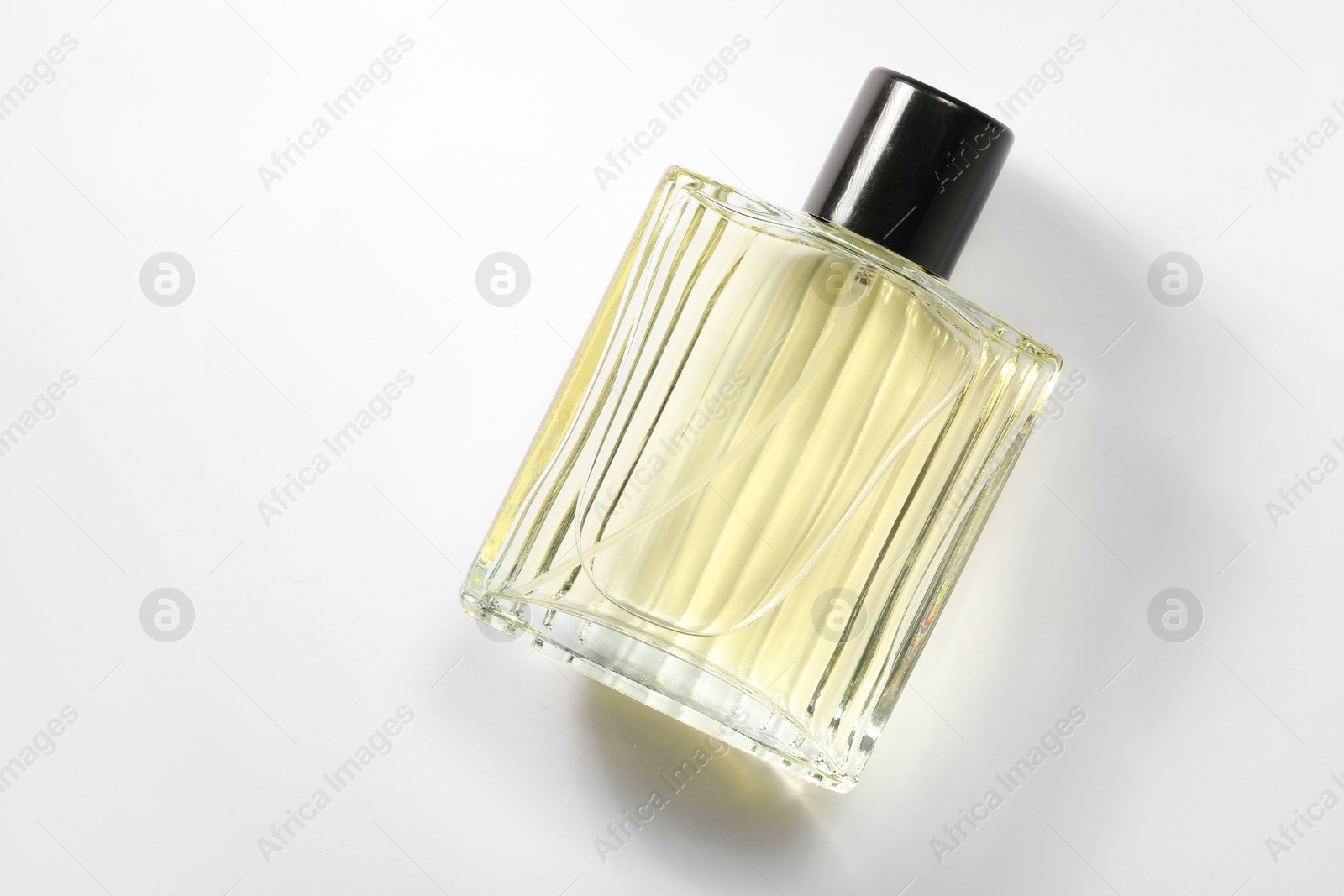 Photo of Luxury men`s perfume in bottle on white background, top view. Space for text