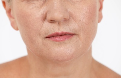 Photo of Beautiful older woman on white background, closeup of lips