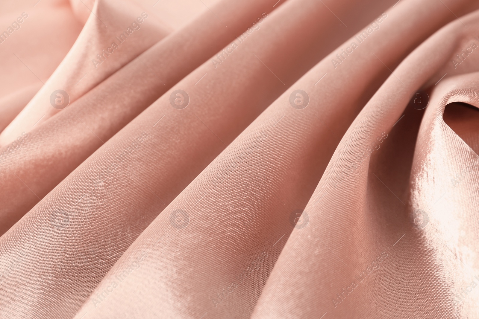 Photo of Texture of rose gold silk as background, closeup