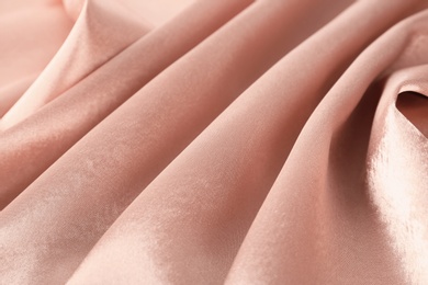 Photo of Texture of rose gold silk as background, closeup