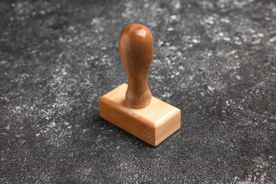 Photo of One wooden stamp tool on dark textured table