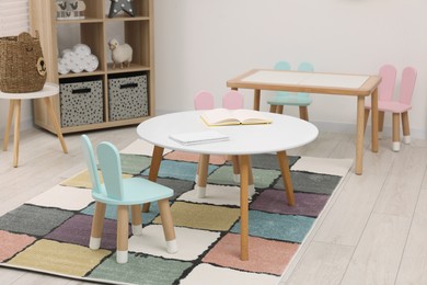 Photo of Stylish kindergarten interior with toys and modern furniture