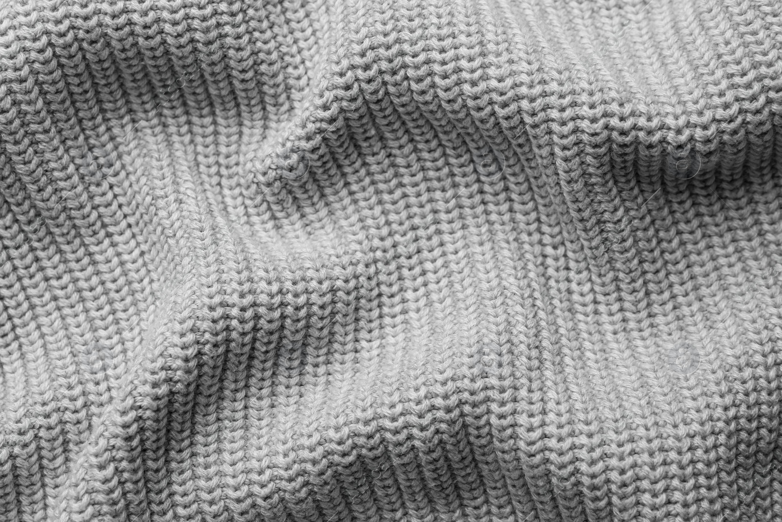 Photo of Grey knitted fabric as background, top view