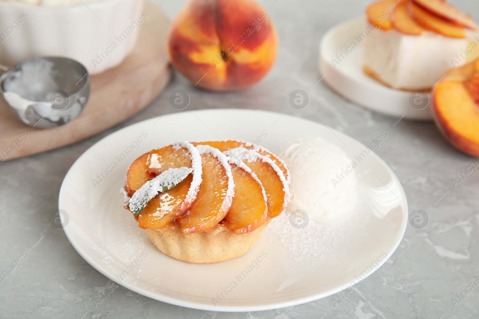 Photo of Delicious peach dessert with ice cream on light marble table