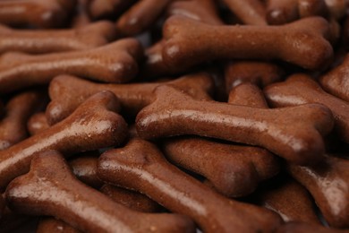 Photo of Many bone shaped dog cookies as background, closeup