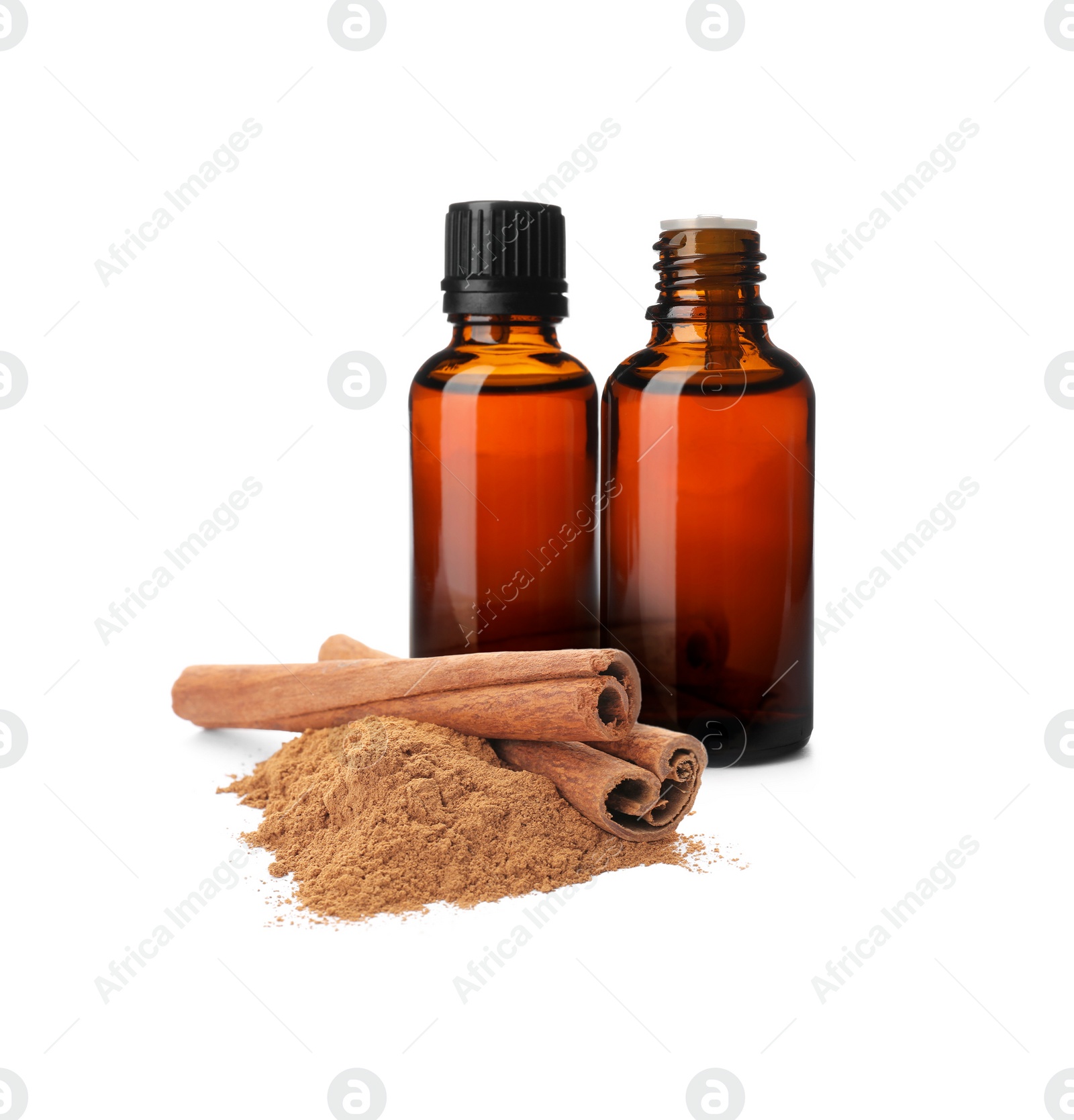 Image of Bottles of natural essential oil, dry cinnamon sticks and powder on white background