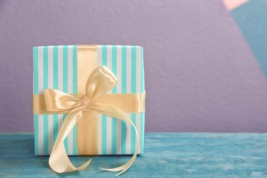 Elegant gift box with bow on table