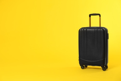 Stylish suitcase on color background. Space for text